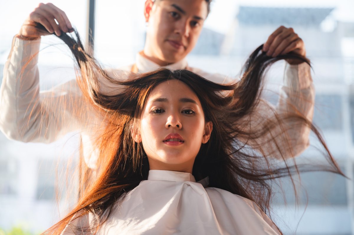 The Real Difference Between Salon and Drugstore Haircare. hairdresser and beautiful client woman making treatment hair health care in fashion style salon.