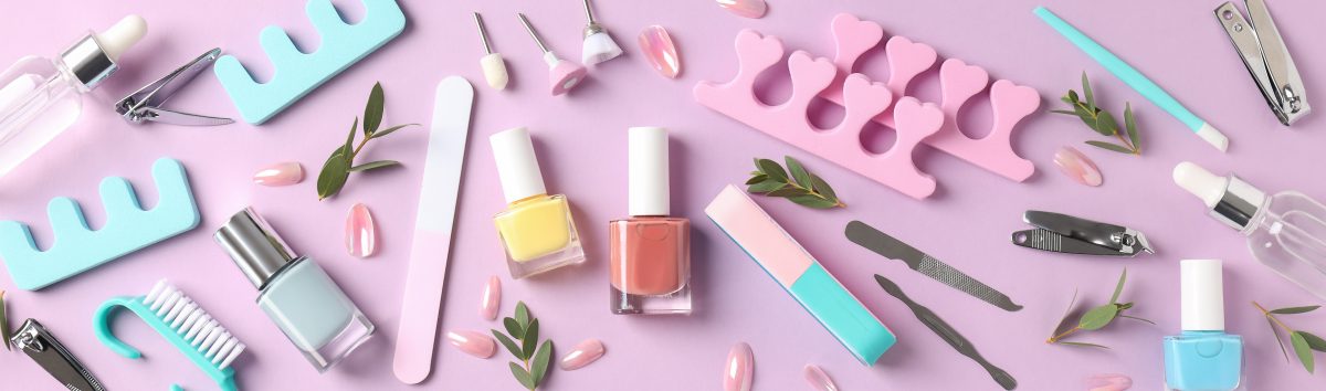 Concept of nail care with manicure accessories on pink background