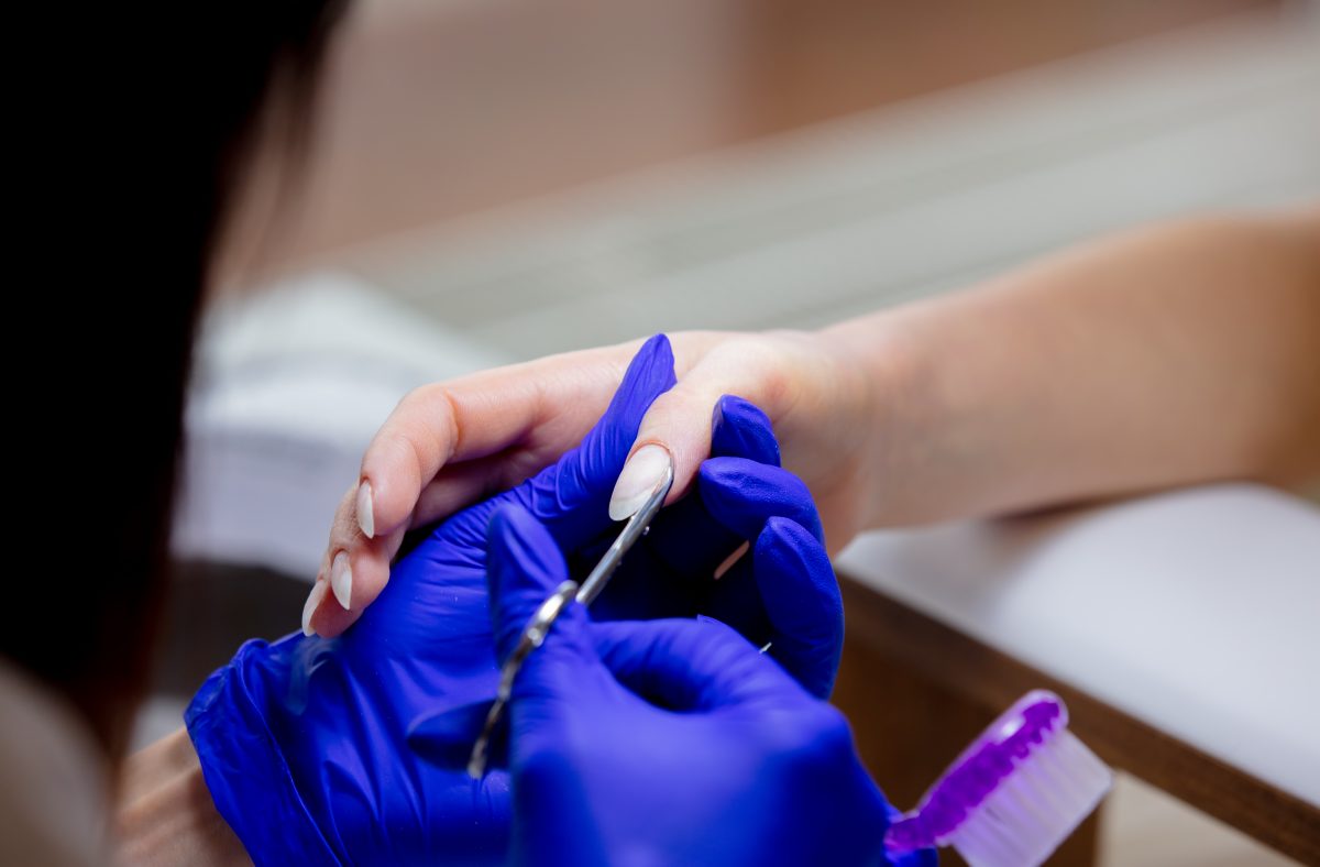 manicure master using scissors for work.
