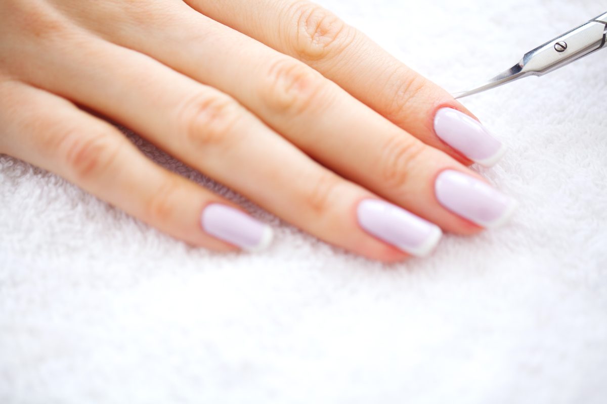 2025 Nail Color Trends. SPA manicure. French manicure at spa salon. Woman hands in a nail salon receiving a manicure procedure. Manicure procedure.