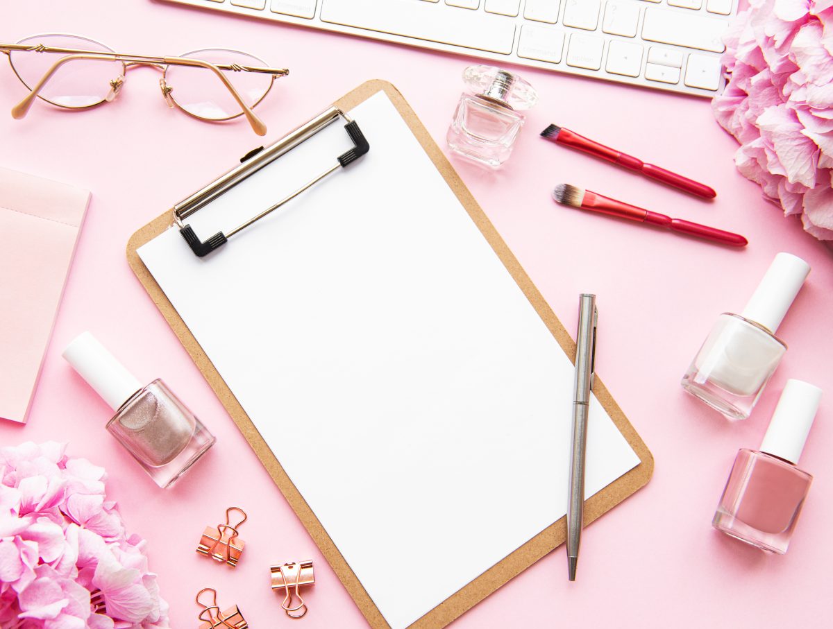 Beauty composition with clipboard, hydrangea, cosmetics and accessory on pink background. Top view. Flat lay. Home feminine desk. home-based nail business.