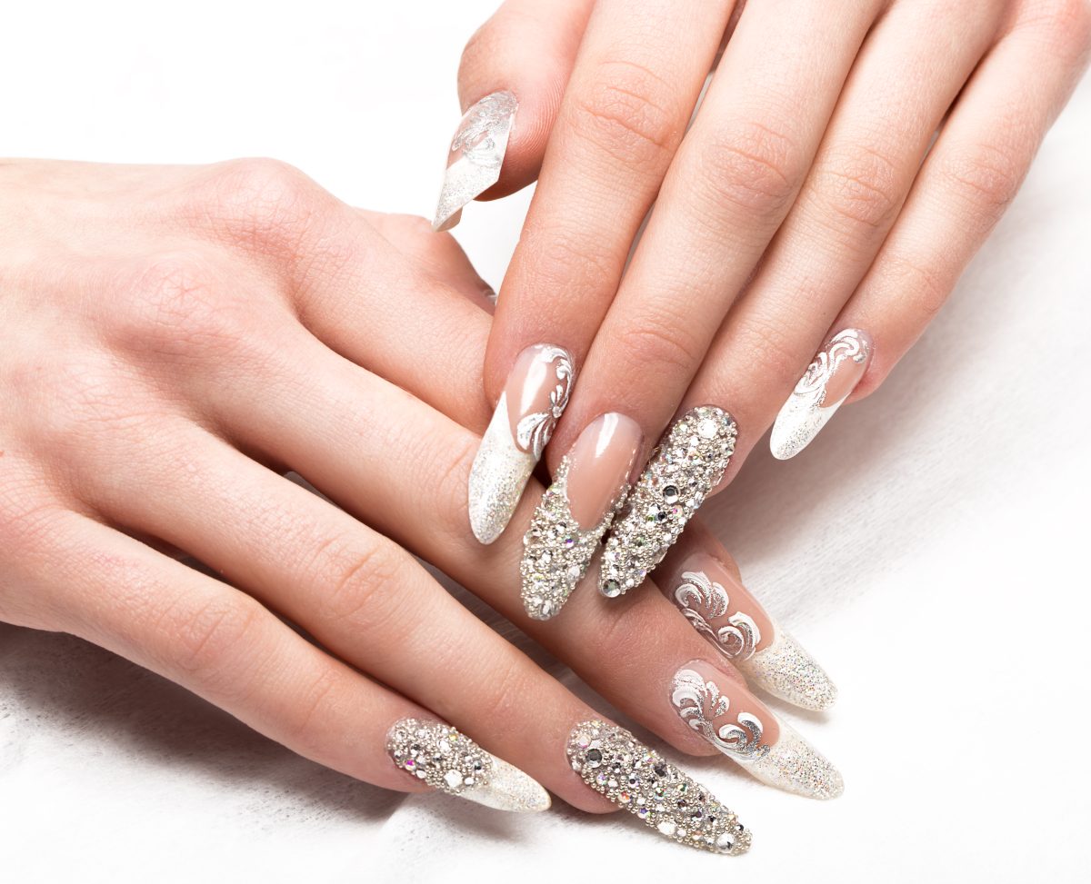 Beautifil wedding manicure for the bride in gentle tones with rhinestone. Nail Design. Close-up.