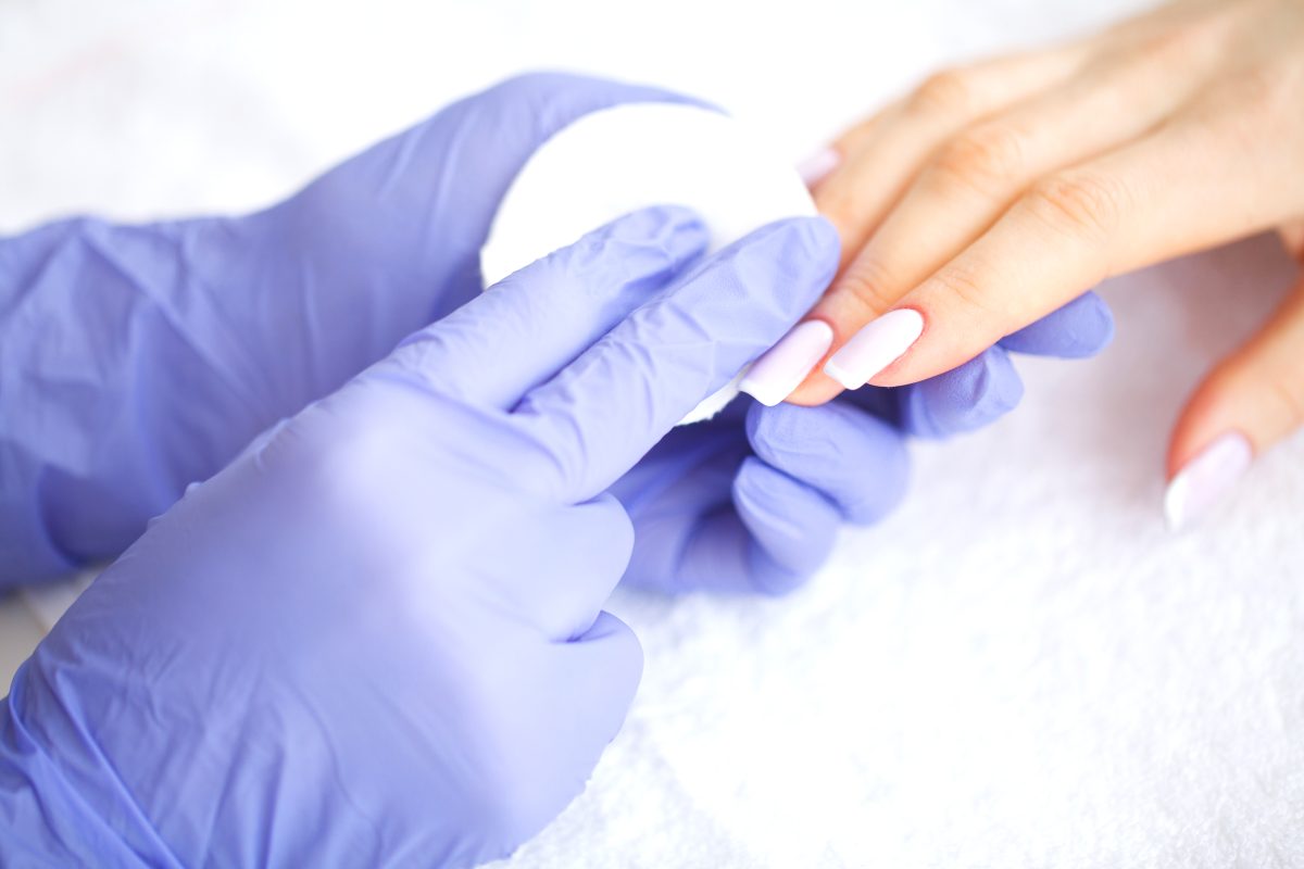 SPA manicure. French manicure at spa salon. Woman hands in a nail salon receiving a manicure procedure. Manicure procedure.