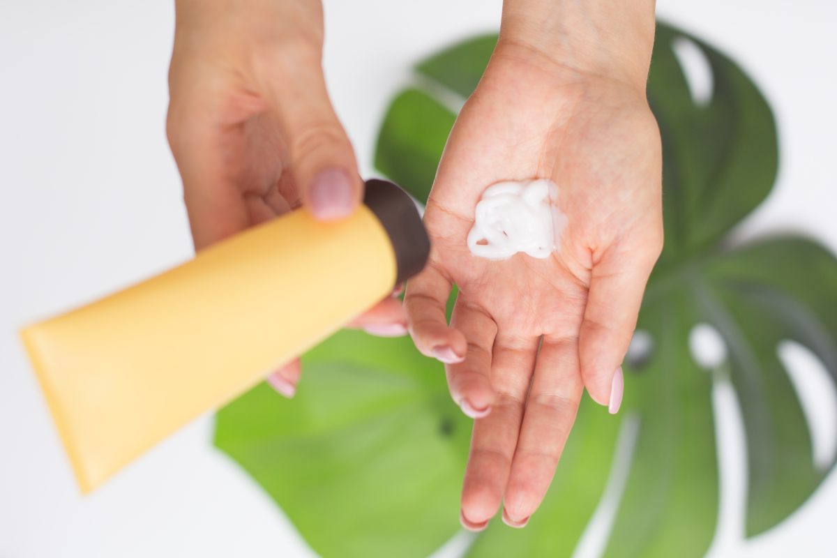 Woman uses hand cream.