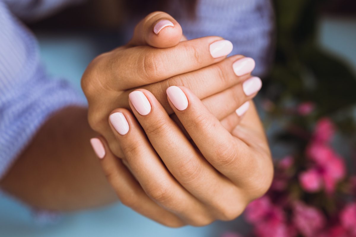 Beautiful woman's nails with beautiful pink manicure. Best Nail Treatments for Weak and Brittle Nails.